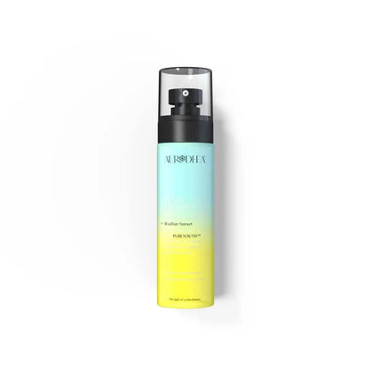Aurodhea Lush Cloud SBM005 – Parfümiertes Körperspray Brazilian Sunset 100 ml mit PUREYOUTH™ Komplex, türkis-gelbe Flasche auf weißem Hintergrund