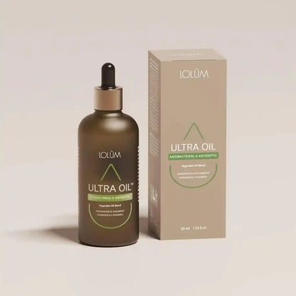 Lolûm Ultra Oil Antibacterial & Antiseptic LO012: Braune Glasflasche mit Pipette neben der beigefarbenen Originalverpackung.